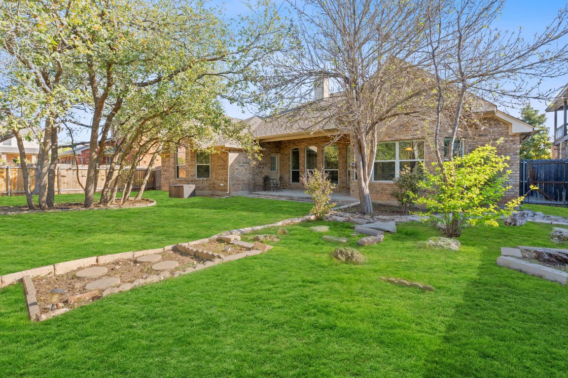 738 Nelson Ranch Road Cedar Park, TX 78613 - Photo 5 of 35 Rear view of property with a yard, a patio area, fence, and brick siding