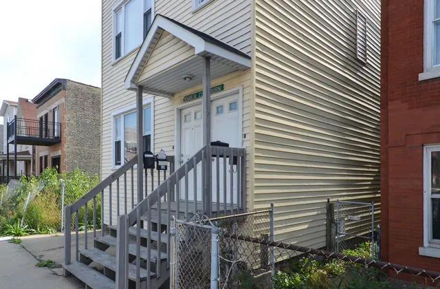 a view of a house with wooden stairs