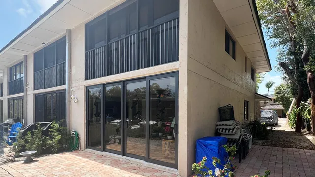a view of a yard with plants and trees