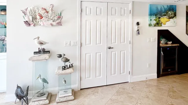a bedroom with a bed a dresser and painting on the wall
