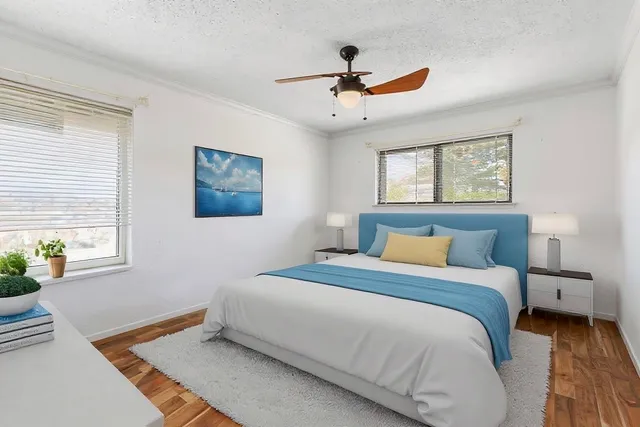 a bedroom with a large bed and a window