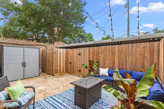 a backyard of a house with barbeque oven table and chairs