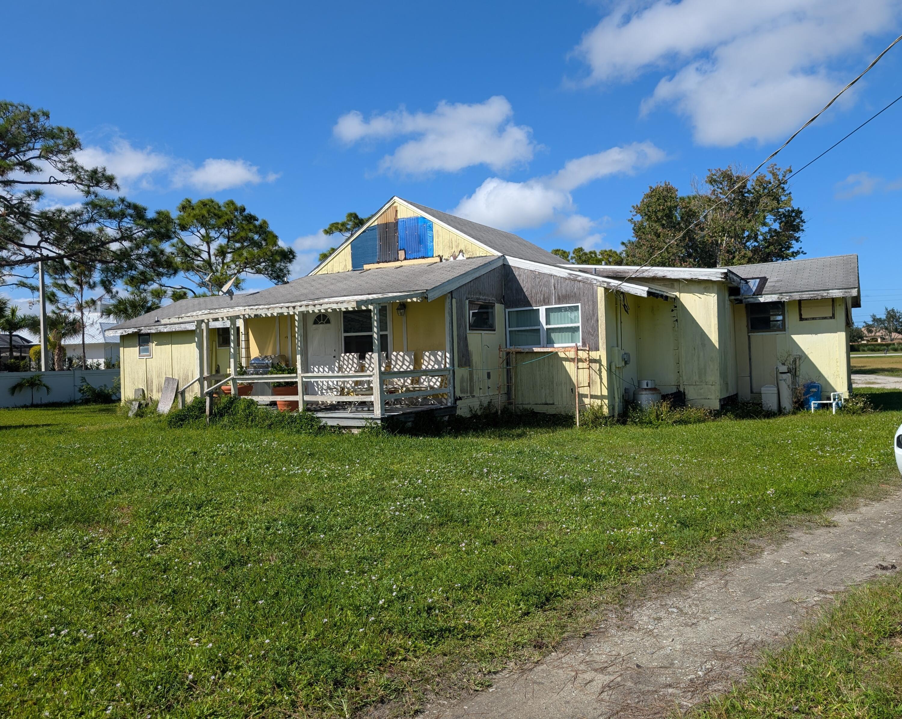 1500 Southeast Cove Road Stuart, FL 34997 - Photo 15 of 25 a front view of house with yard and green space