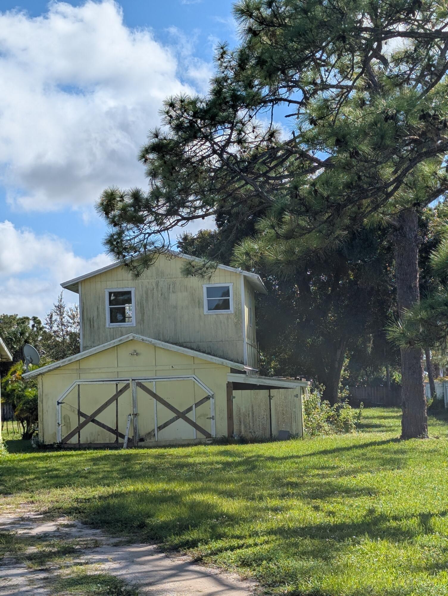 1500 Southeast Cove Road Stuart, FL 34997 - Photo 19 of 25 a view of a big house with a big yard