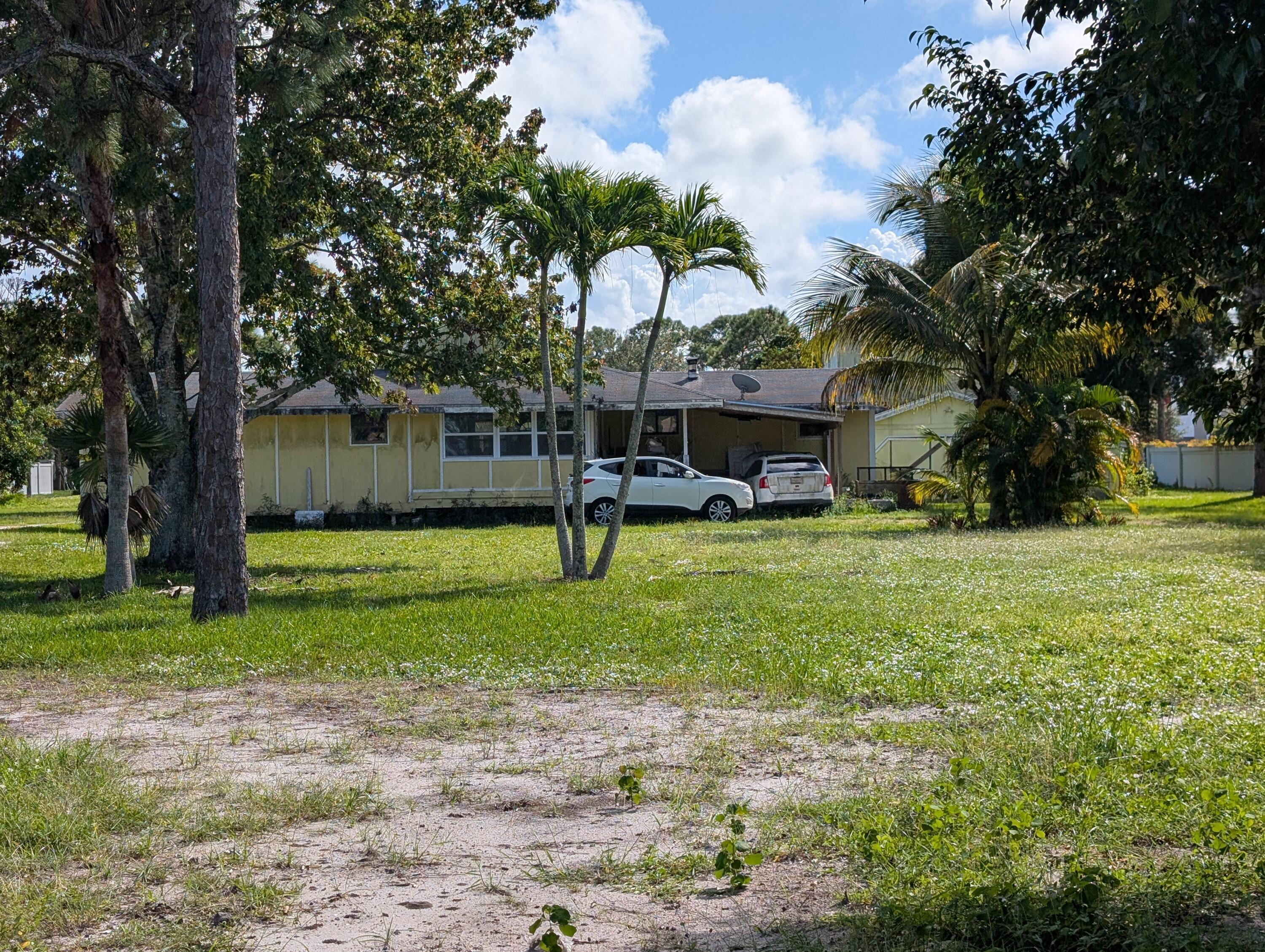 1500 Southeast Cove Road Stuart, FL 34997 - Photo 20 of 25 a view of a house with a backyard