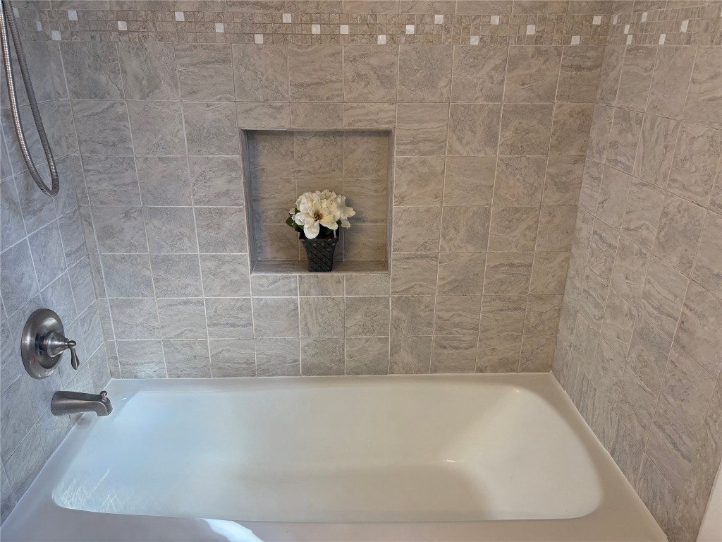 1111 Burning Tree Road Kingwood, TX 77339 - Photo 19 of 32 Stylish guest bath featuring a remodeled tiled tub area.