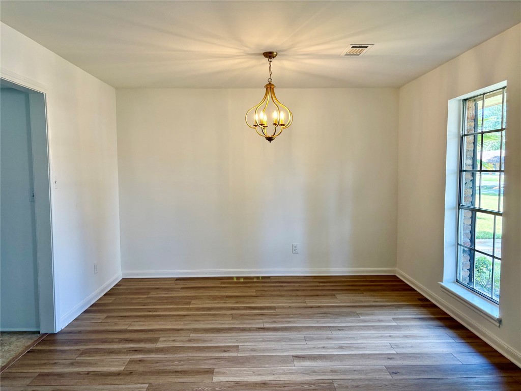 1111 Burning Tree Road Kingwood, TX 77339 - Photo 5 of 32 This formal dining area flows into the "extra room" room, showcasing modern lighting, new flooring, and fresh paint.