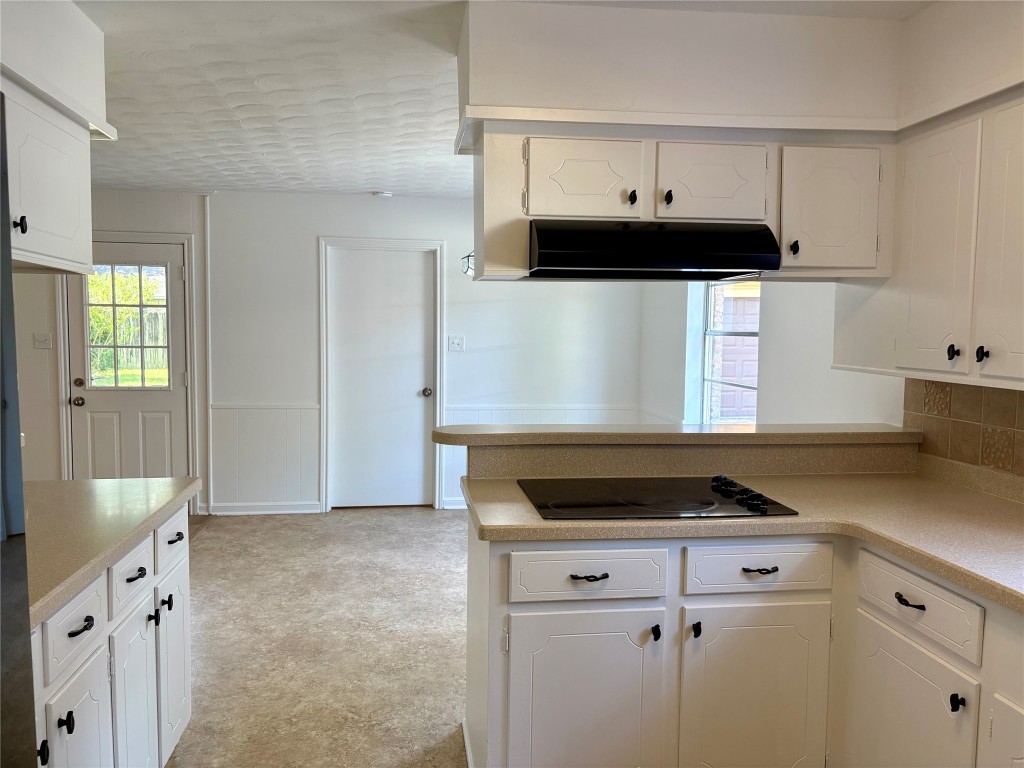 1111 Burning Tree Road Kingwood, TX 77339 - Photo 10 of 32 The kitchen is open to the breakfast room and dining room. There's easy access to the outdoors through a nearby door, enhancing natural light.