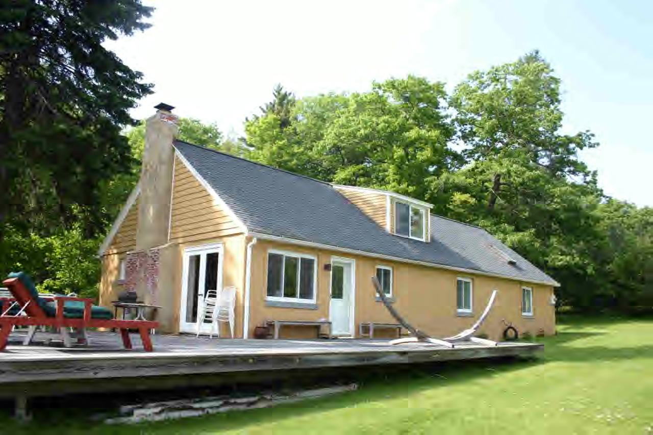 a front view of a house with a yard table and chairs