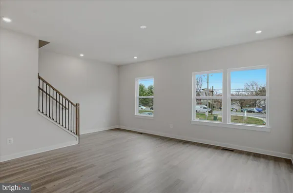 a view of entryway and kitchen with wooden floor