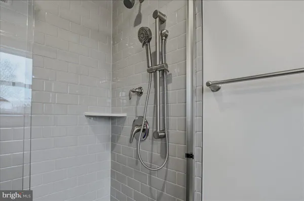 a bathroom with a sink mirror shower and toilet