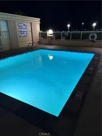 a blue swimming pool with chairs