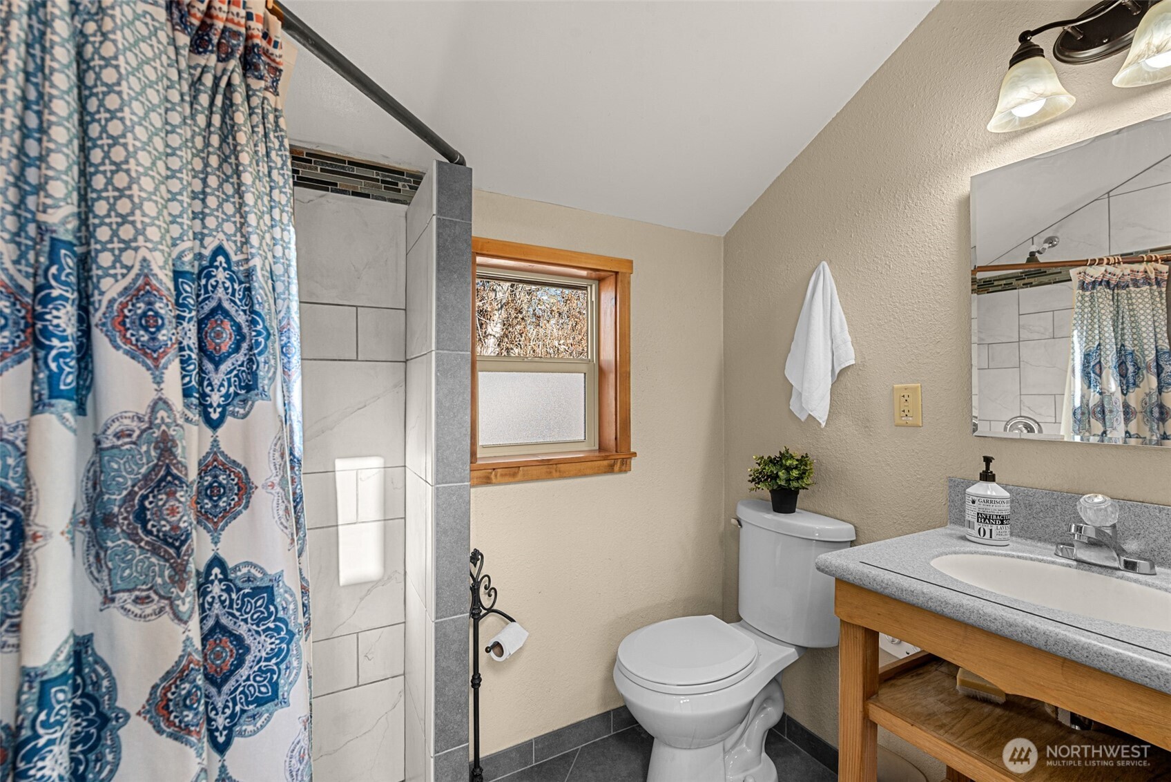 75 Purtteman Gulch Road Chelan, WA 98816 - Photo 20 of 40 a bathroom with a granite countertop toilet sink and mirror