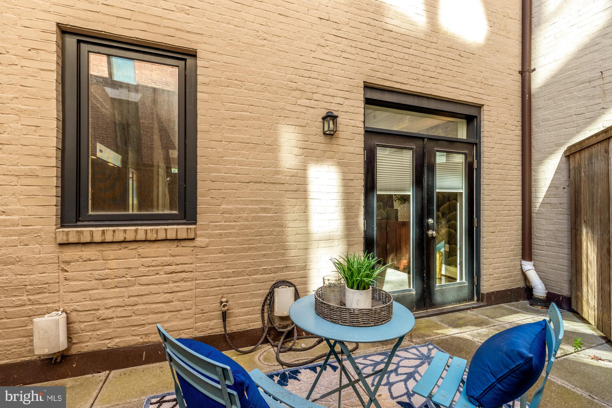 1533 P Street Northwest, Unit 5 Washington, DC 20005 - Photo 14 of 28 a view of a house with a chairs and table in a patio