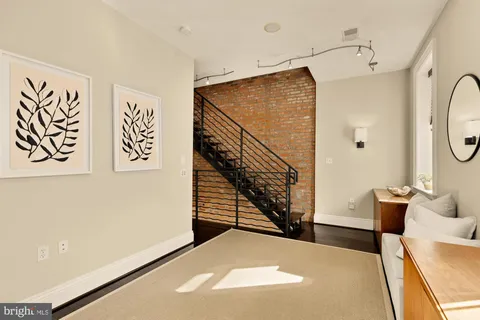 a view of entryway and hall with wooden floor