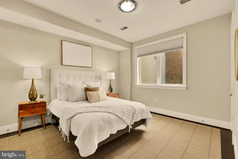 a bedroom with a bed and a night stand