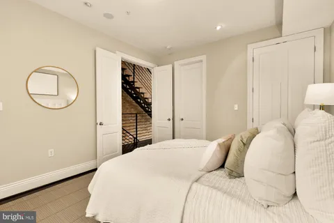 a bedroom with a bed and a potted plant