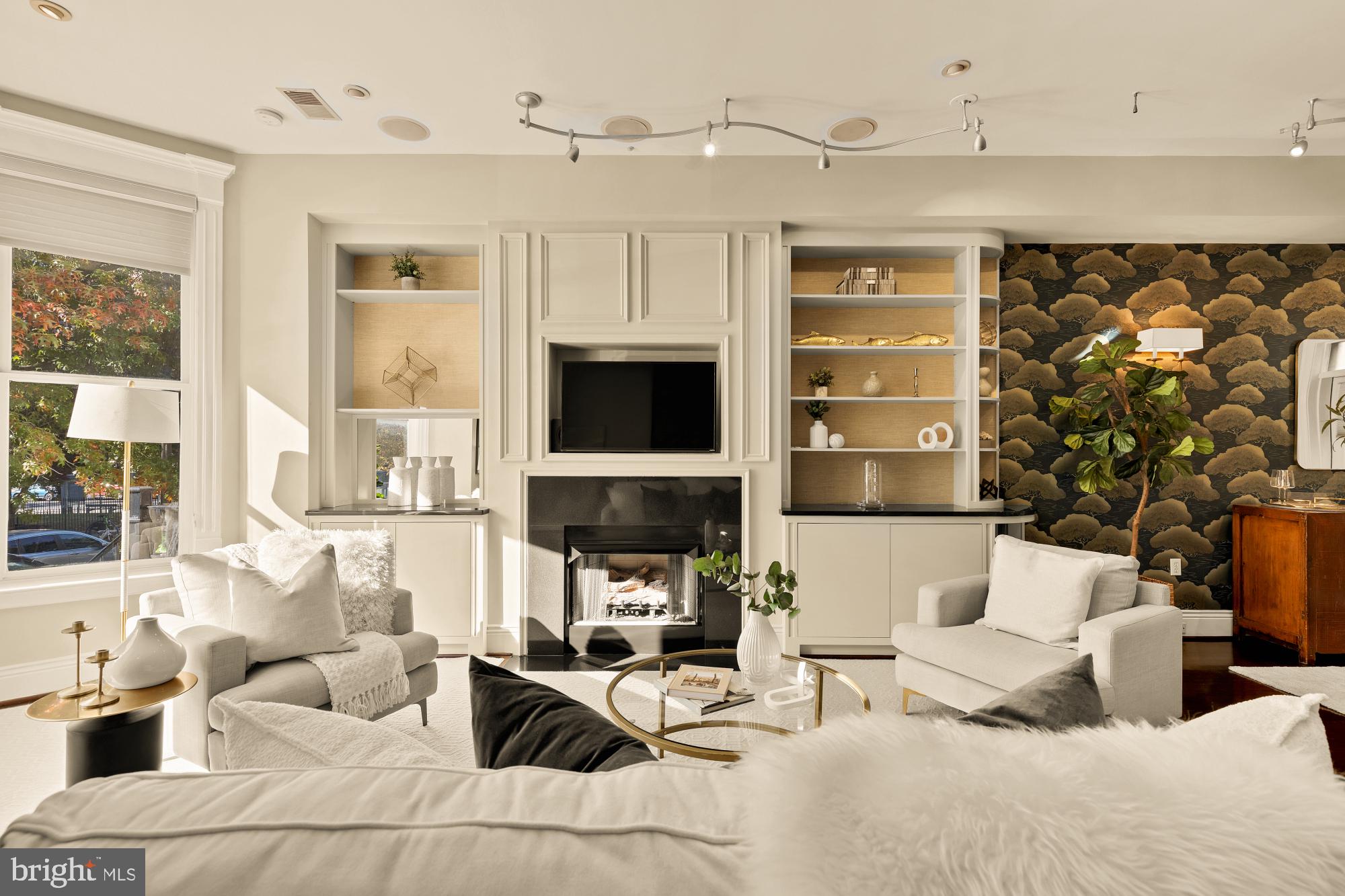 1533 P Street Northwest, Unit 5 Washington, DC 20005 - Photo 3 of 28 a living room with furniture a fireplace and a flat screen tv