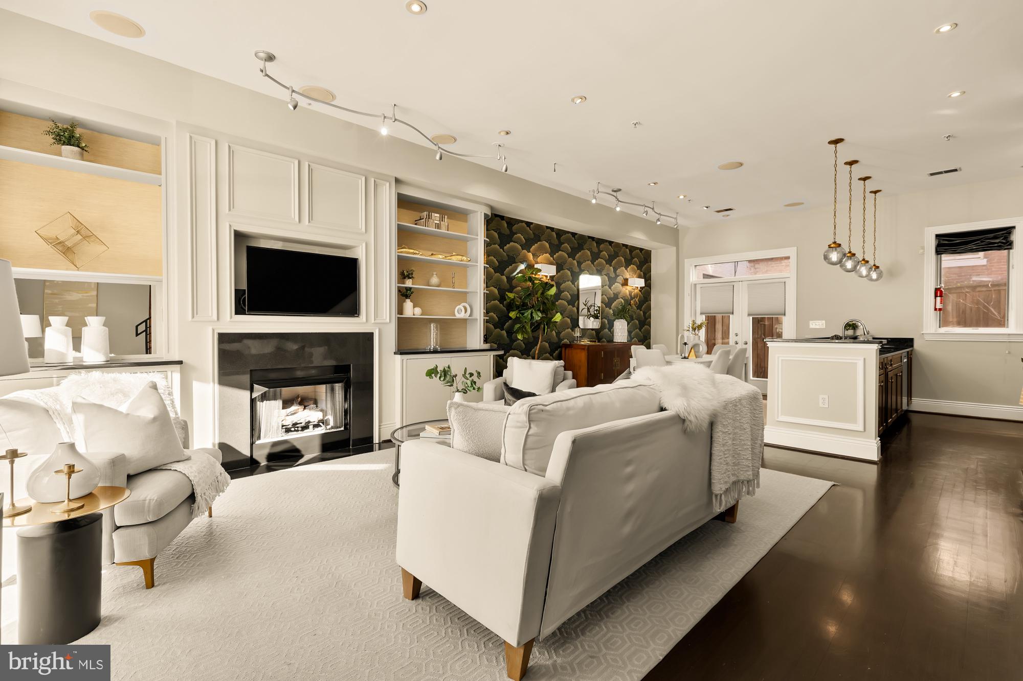1533 P Street Northwest, Unit 5 Washington, DC 20005 - Photo 4 of 28 a living room with furniture a fireplace and a flat screen tv