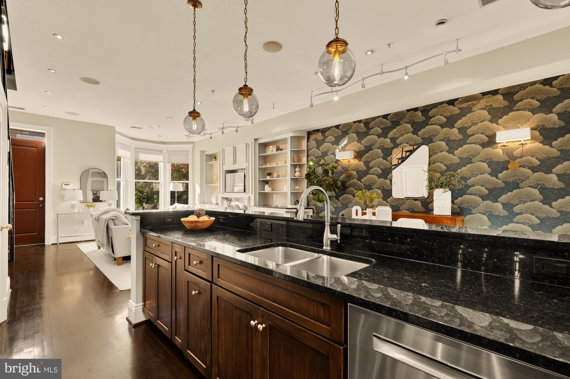 1533 P Street Northwest, Unit 5 Washington, DC 20005 - Photo 10 of 28 a kitchen with stainless steel appliances granite countertop a sink a stove and a wooden floor
