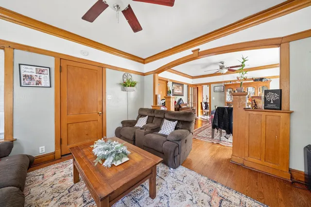 a living room with furniture and wooden floor