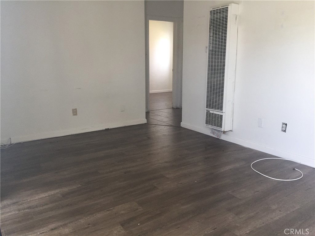 150 East 57th Street, Unit 3 Long Beach, CA 90805 - Photo 2 of 4 an empty room with wooden floor and windows