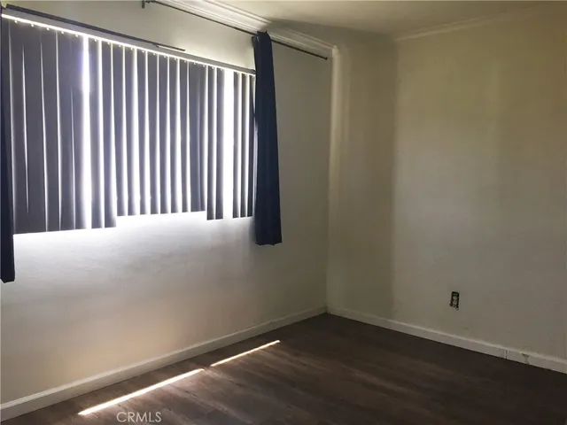 a view of a room with wooden floor