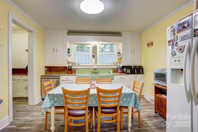 a dining room with furniture and a kitchen view