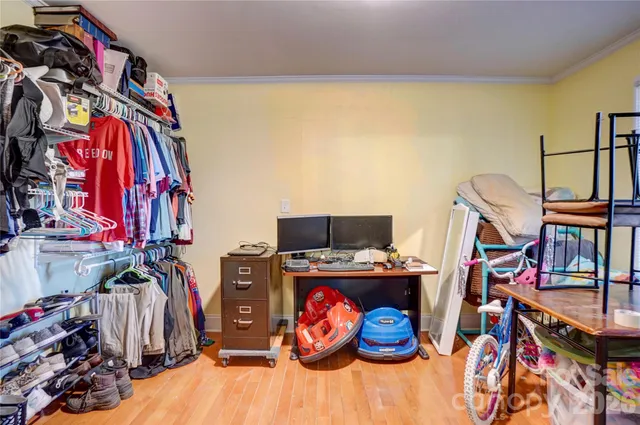 a view of walk in closet with clothes and shoes