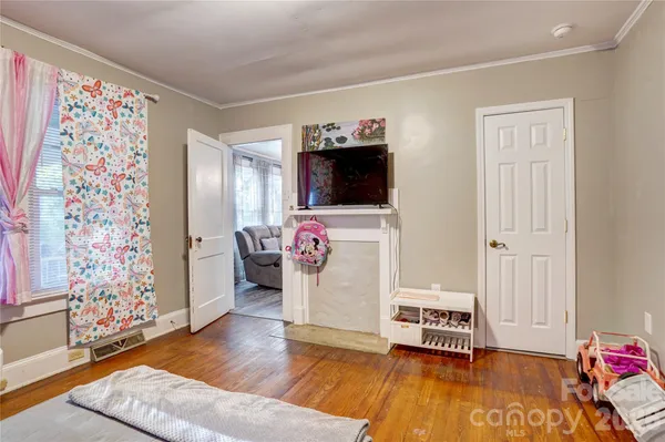 a spacious bedroom with a bed and a table in it
