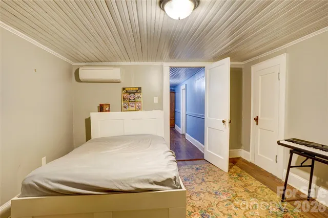 a spacious bedroom with a bed and a table in it