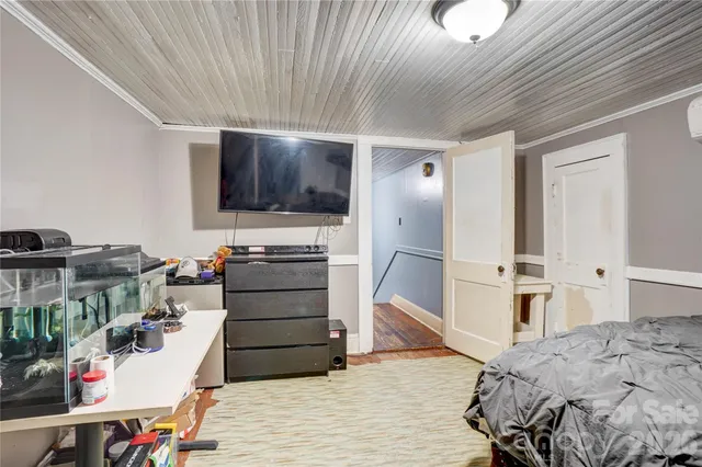 a bed room with a bed and a television