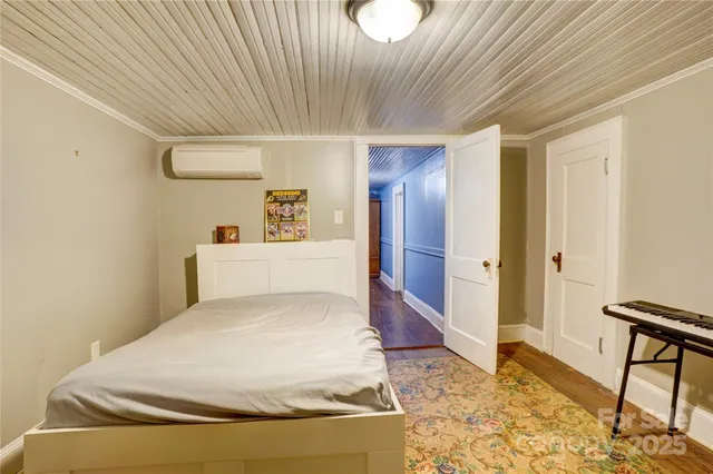 a spacious bedroom with a bed and a table in it