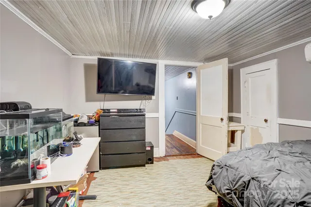 a bed room with a bed and a television