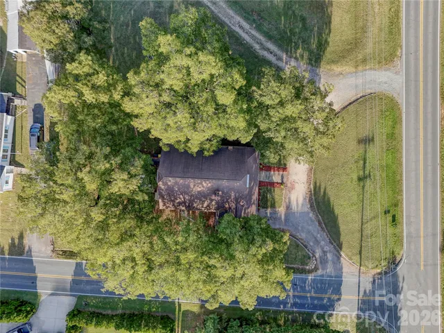 an aerial view of a residential houses with yard