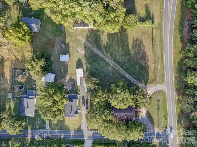 an aerial view of residential houses with outdoor space and street view