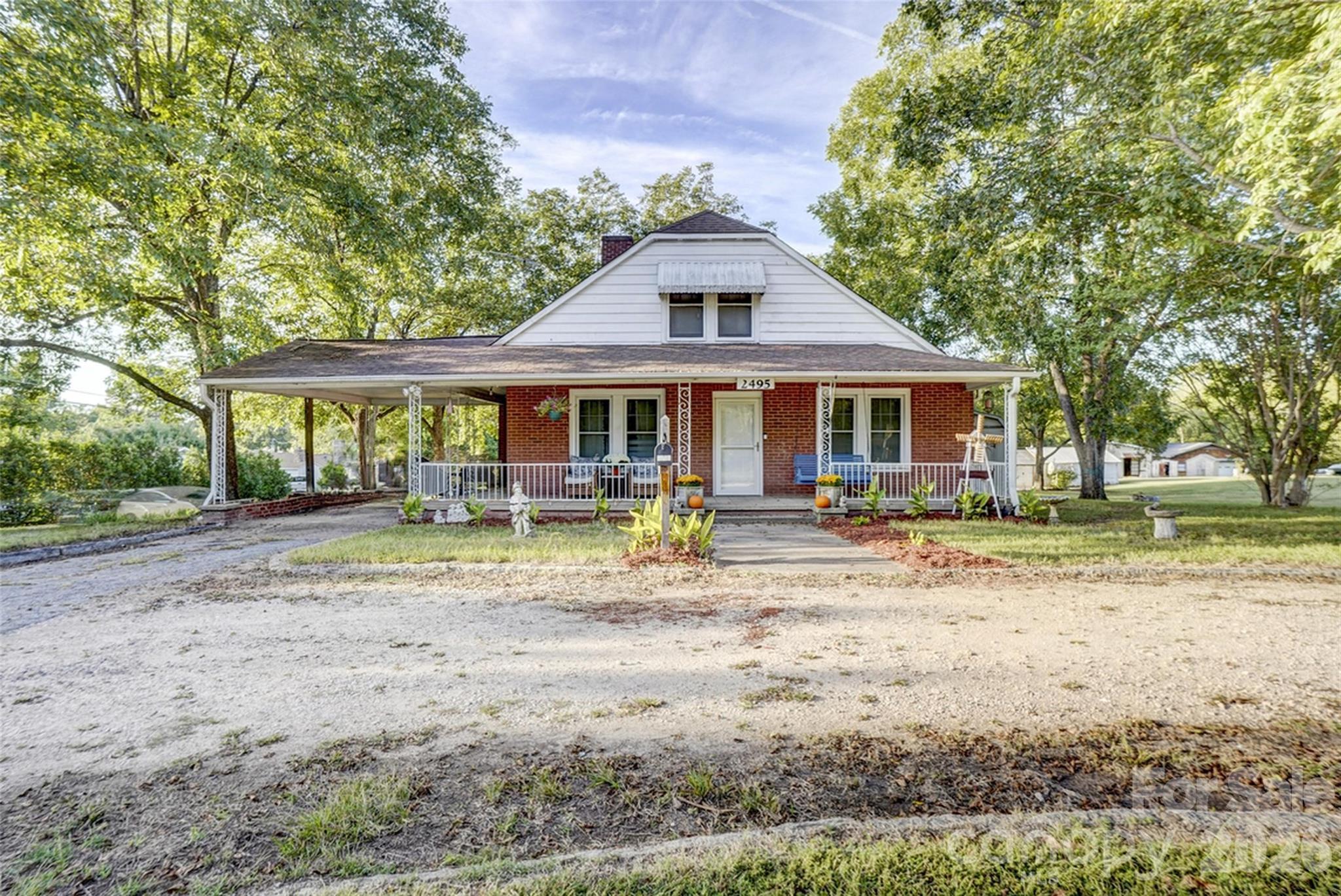 2495 Centergrove Road Kannapolis, NC 28083 - Photo 33 of 36 a view of a white house with a yard plants and large tree