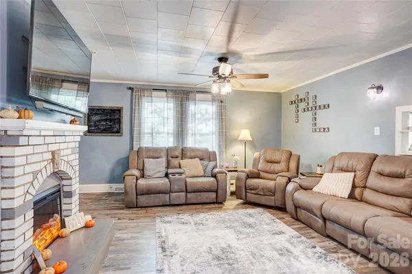 a living room with furniture fireplace and flat screen tv