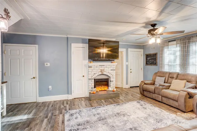 a living room with furniture fireplace and flat screen tv