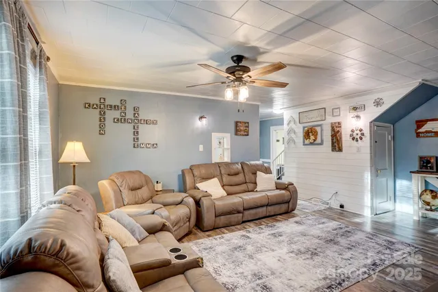 a living room with furniture ceiling fan and a rug