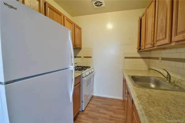 a kitchen with a sink and a refrigerator