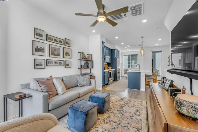 a living room with furniture kitchen view and a table