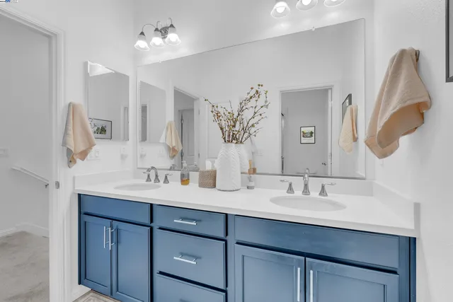 a bathroom with a double vanity sink and a mirror