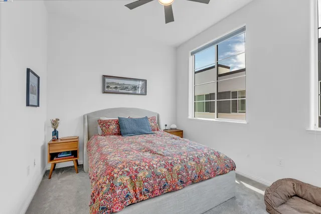 a bedroom with a bed dresser and a window