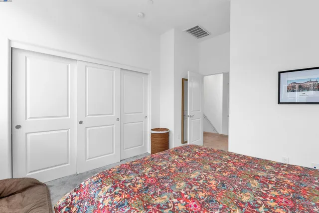 a bedroom with a bed and a closet