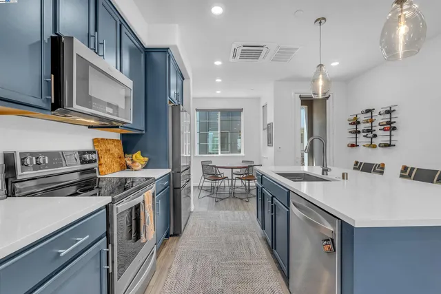 a kitchen with stainless steel appliances granite countertop a stove and a sink