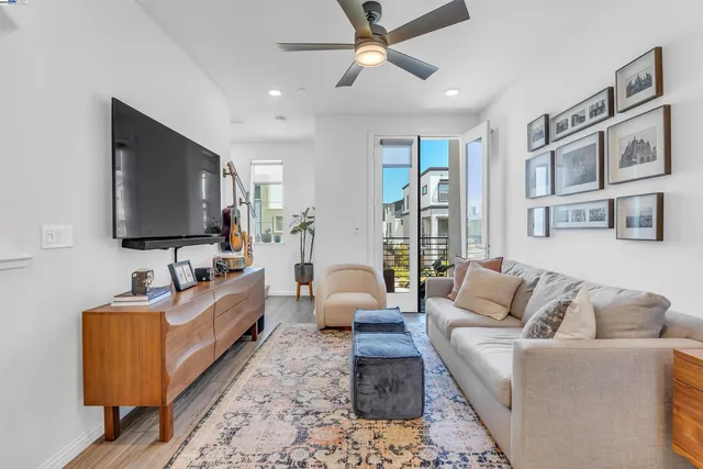 a living room with furniture wooden floor and a flat screen tv