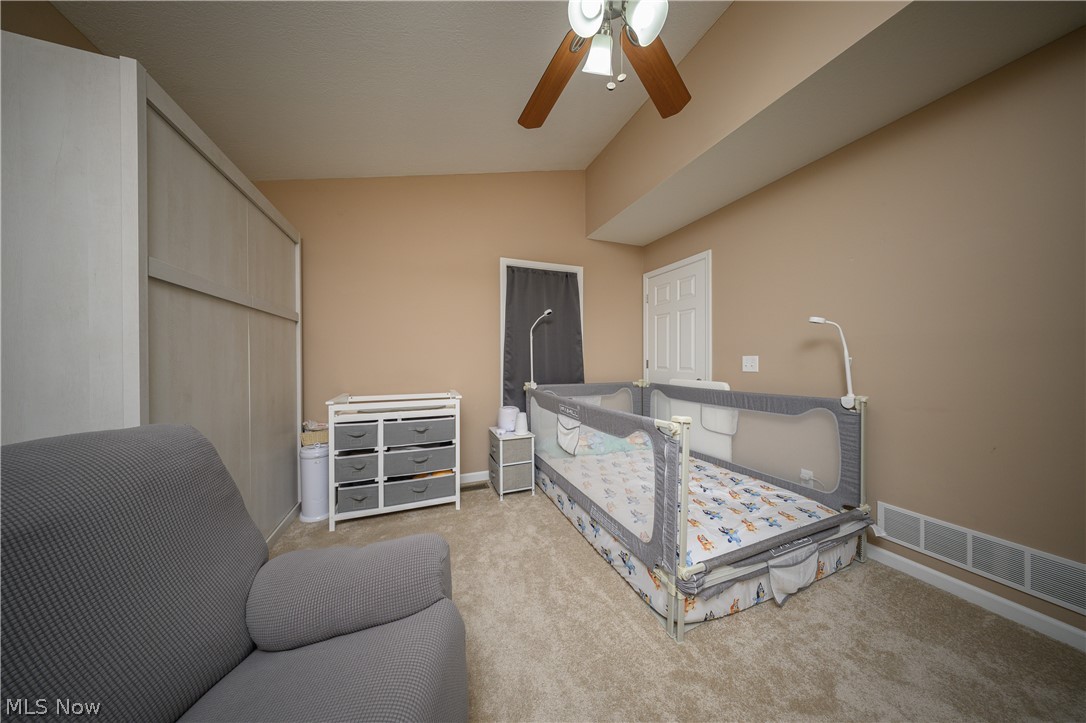 4431 7th Street Northwest Canton, OH 44708 - Photo 5 of 23 Bedroom featuring Murphy Bed, lofted ceiling, a ceiling fan, and light colored carpet
