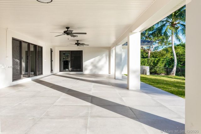a view of a porch with a floor to ceiling window and a yard