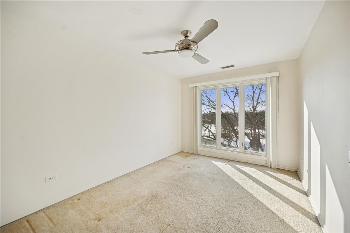 1721 Mission Hills Road, Unit 406 Northbrook, IL 60062 - Photo 13 of 23 an empty room with windows